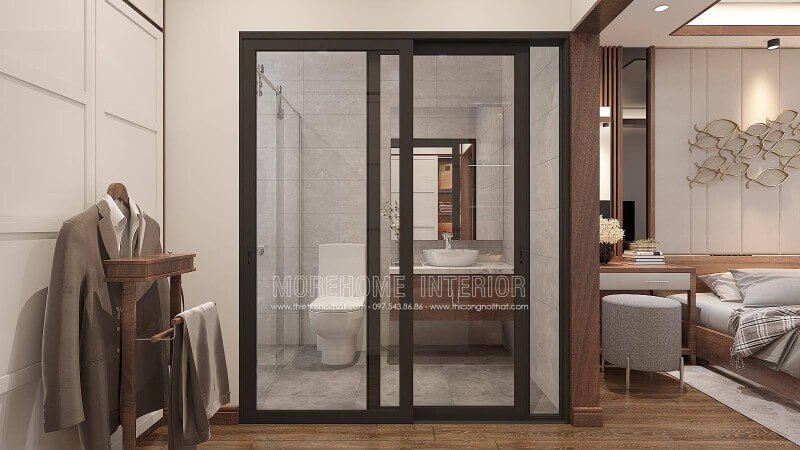Bố trí nội thất phòng ngủ khép kín với xu hướng mở khi sử dụng tấm ốp tường gỗ óc chó như tạo ranh giới phân chia cùng bố trí cửa kính trượt.